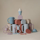 Mushie izglītojoša silikona zobu birste (Shifting Sand) 